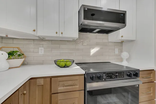 a kitchen with a stove and a microwave
