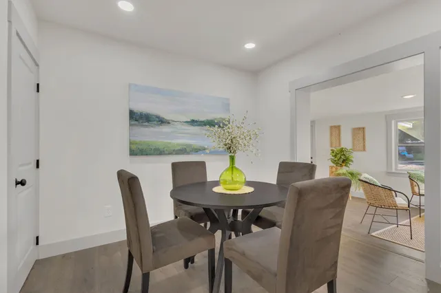 a view of a dining room with furniture and a potted plant