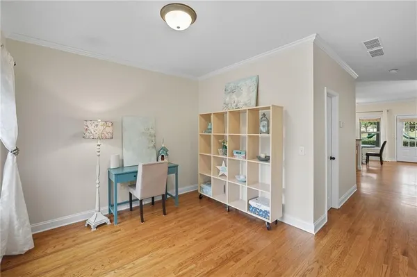 a living room with furniture a flat screen tv and a large window