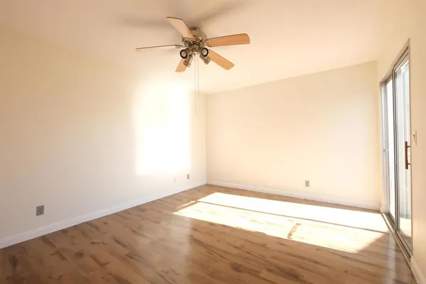a view of a room with wooden floor