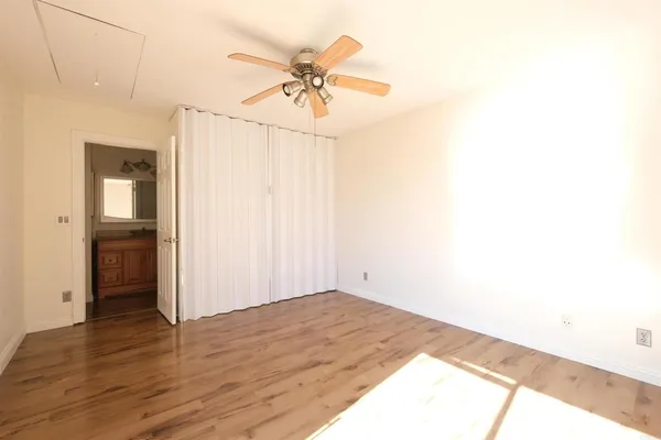 a view of empty room with wooden floor