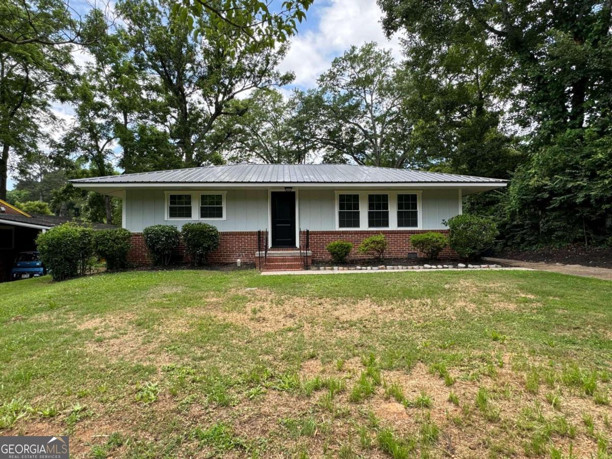 a front view of house with yard and green space