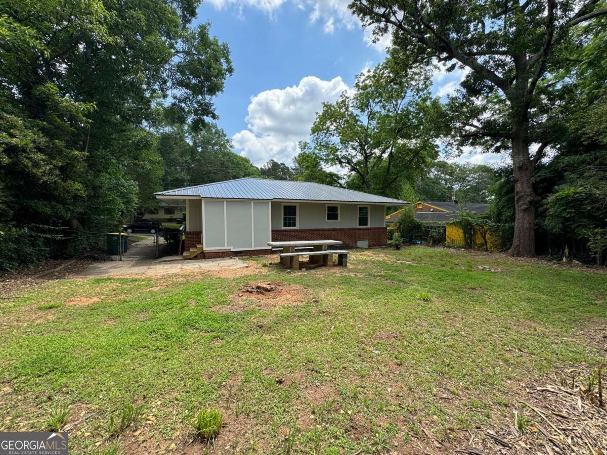 285 Willow Run Athens, GA 30606 - Photo 11 of 12 a backyard of a house with table and chairs under an umbrella