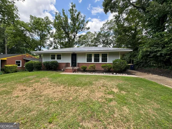 a front view of house with yard and green space
