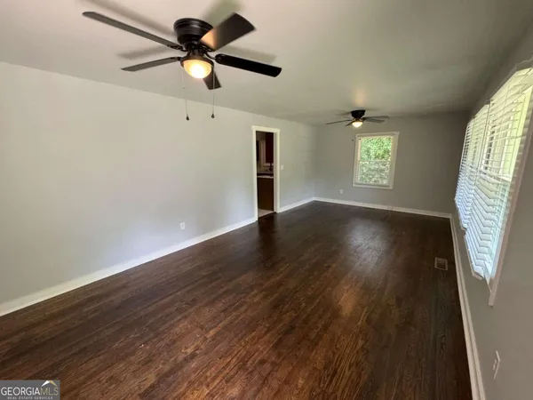 wooden floor in an empty room with a window