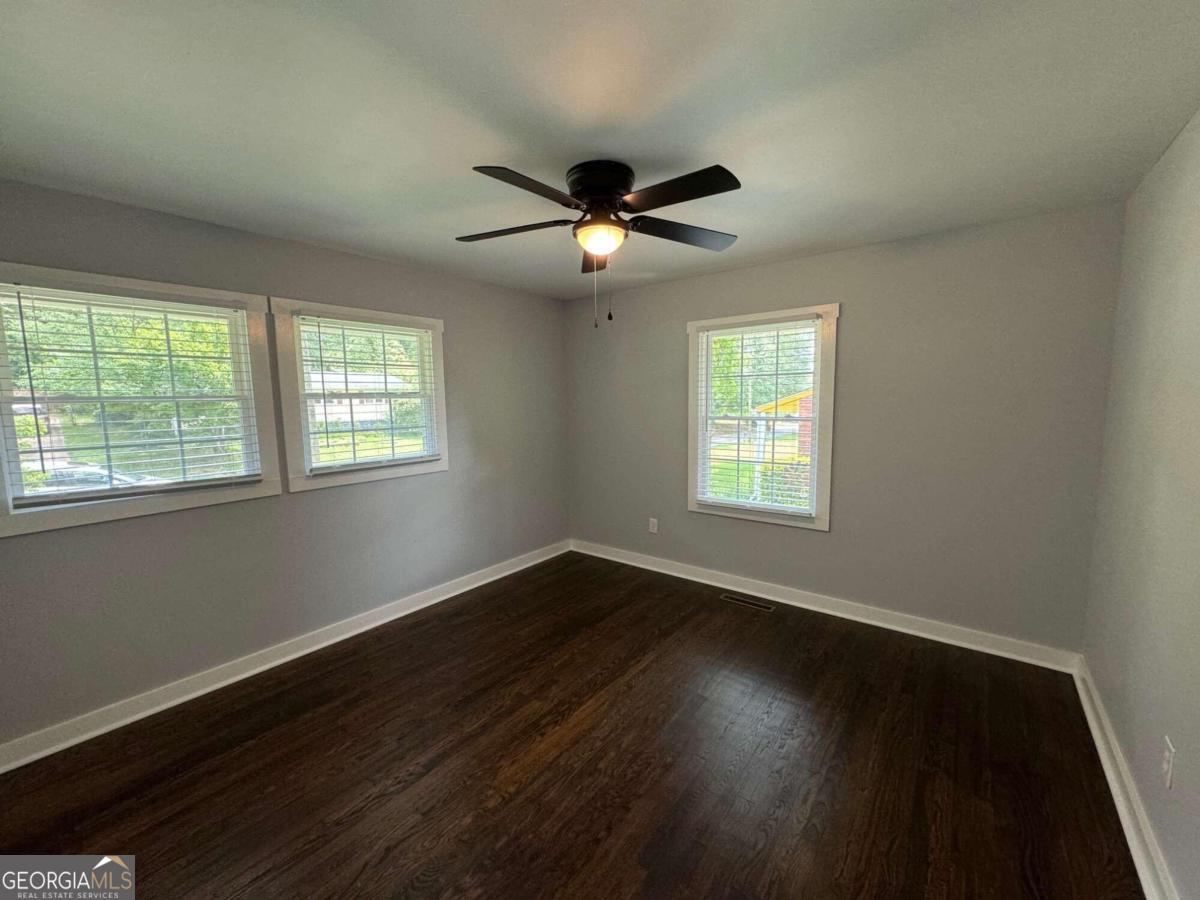 285 Willow Run Athens, GA 30606 - Photo 7 of 12 a view of an empty room with wooden floor and a window