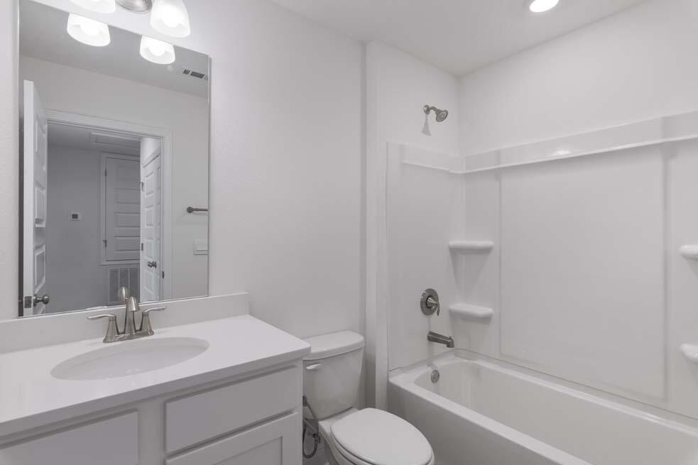 29 Phoenix Street Santa Rosa Beach, FL 32459 - Photo 18 of 26 a bathroom with a granite countertop sink toilet and shower