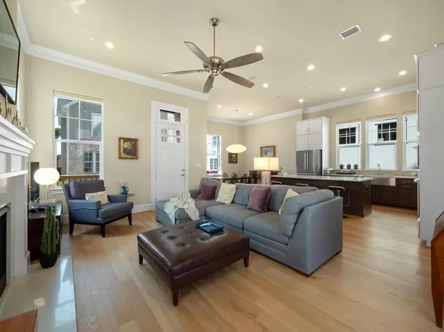 a living room with furniture and a view of kitchen