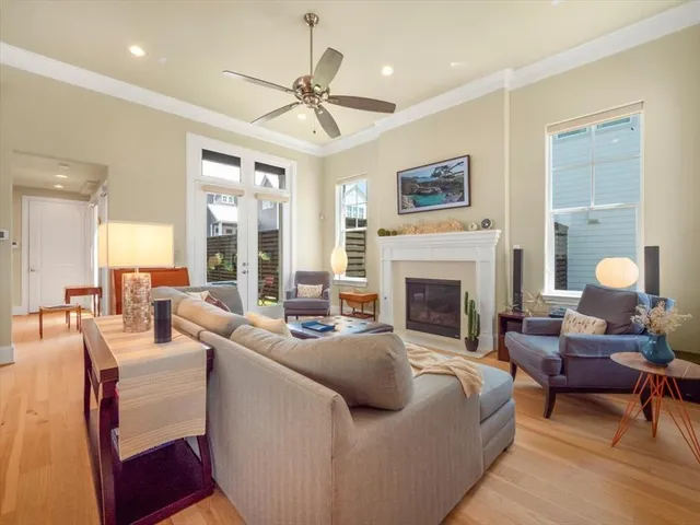 a living room with furniture a fireplace and a chandelier