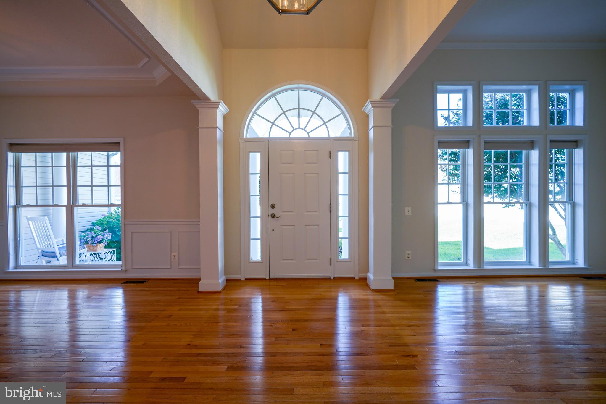 34953 Compass Cove Lewes, DE 19958 - Photo 11 of 90 a view of front door with hallway and wooden floor