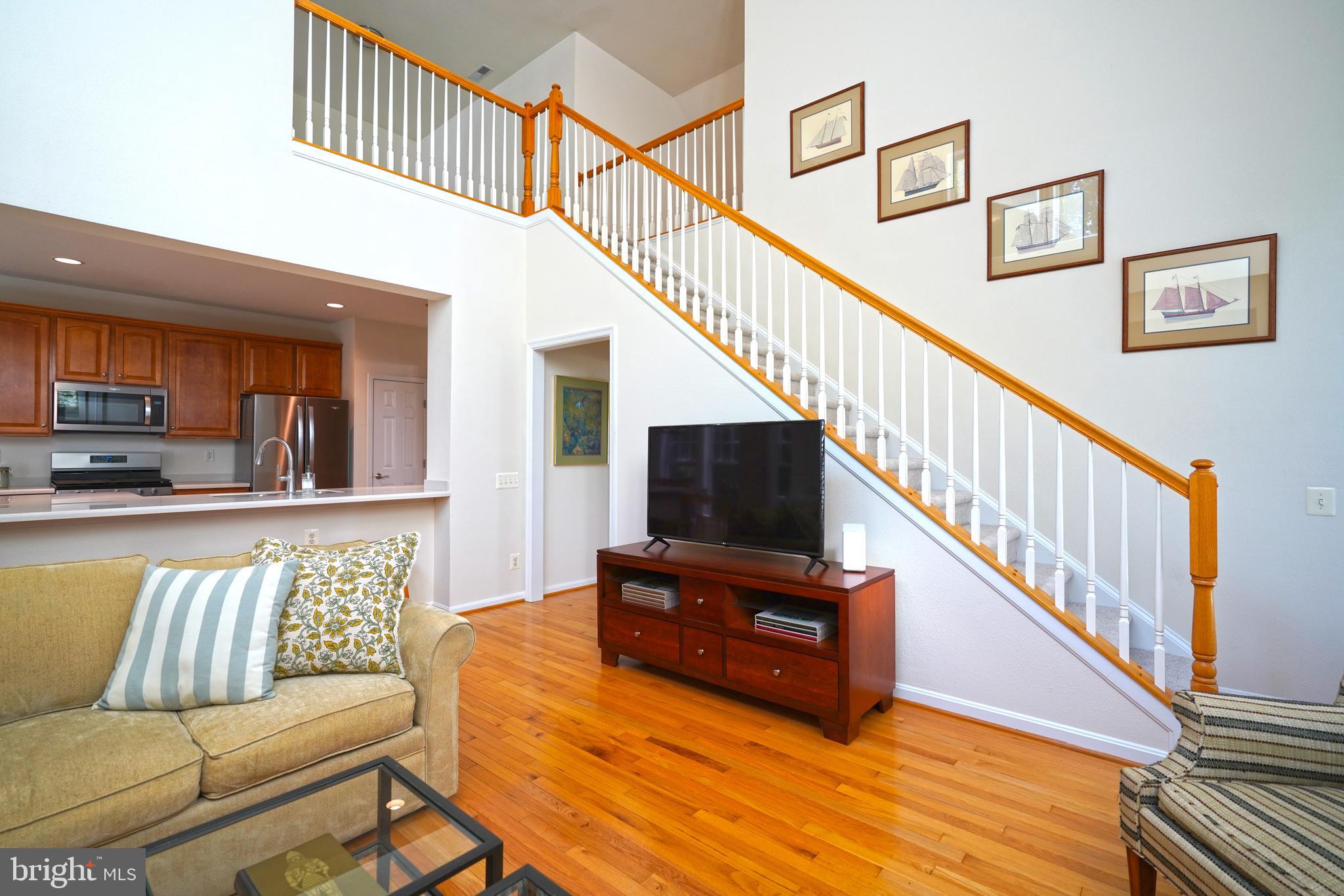 34953 Compass Cove Lewes, DE 19958 - Photo 15 of 90 a living room with furniture and a flat screen tv