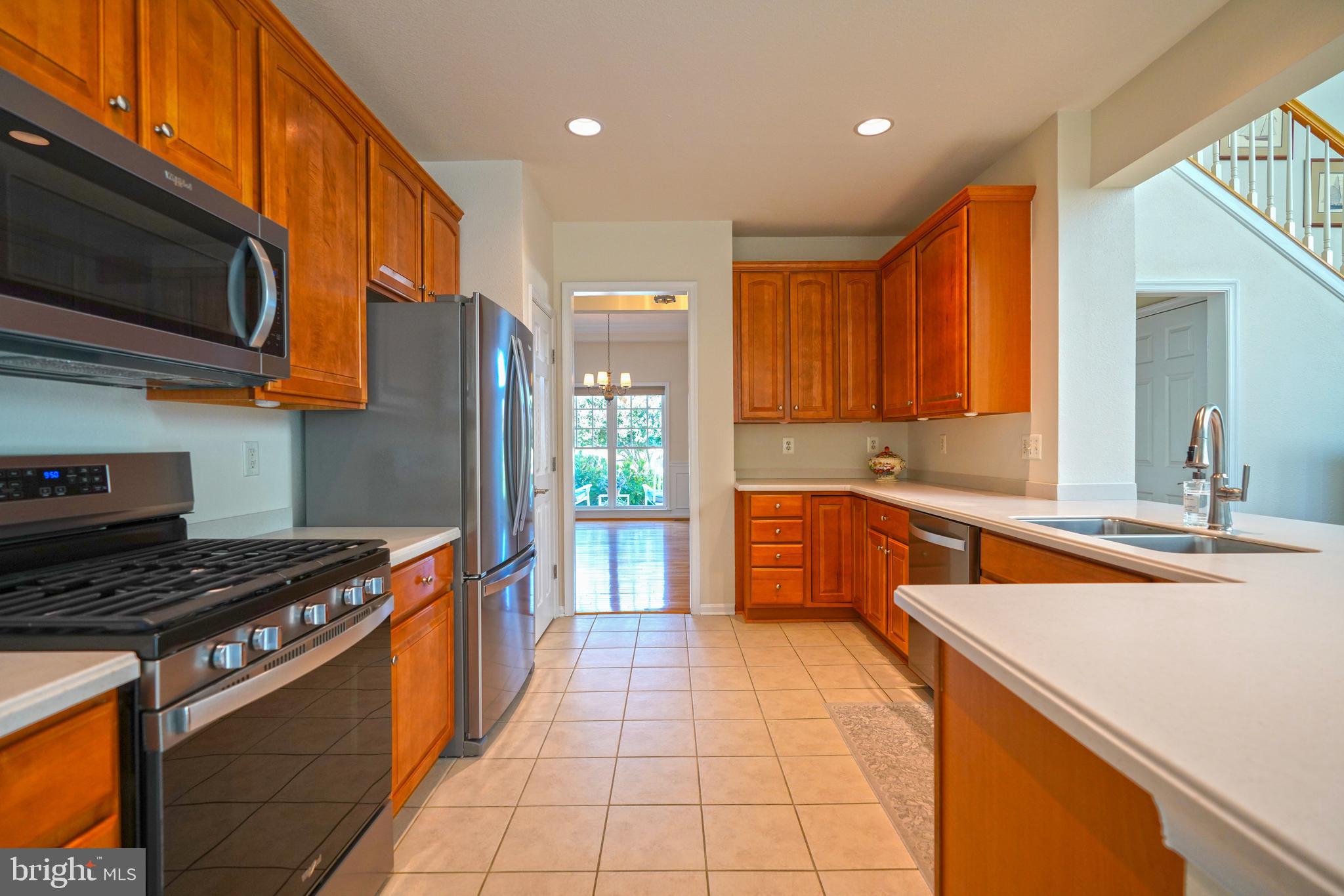 34953 Compass Cove Lewes, DE 19958 - Photo 24 of 90 a kitchen with stainless steel appliances granite countertop a stove a sink and a microwave