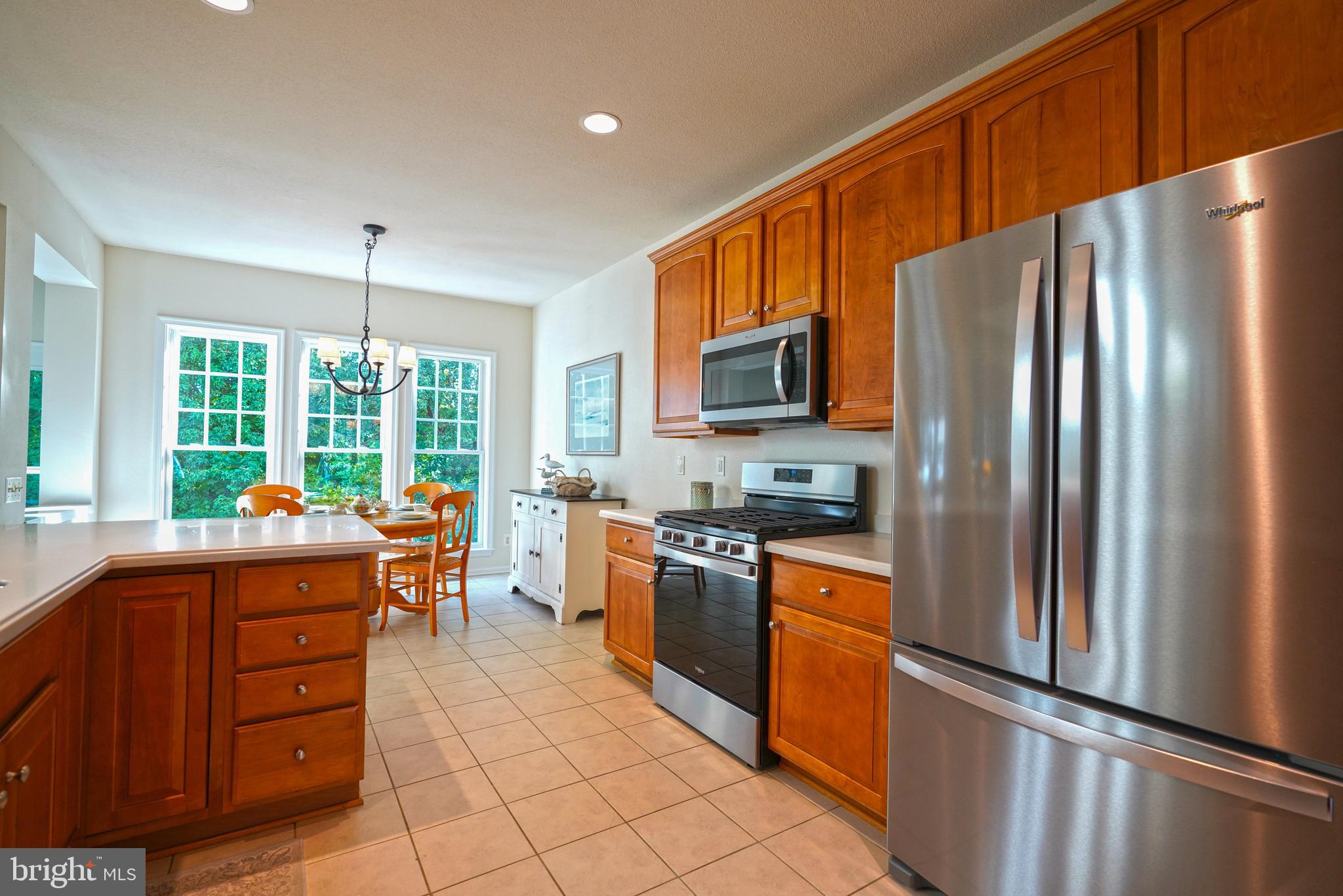 34953 Compass Cove Lewes, DE 19958 - Photo 26 of 90 a kitchen with stainless steel appliances granite countertop a refrigerator stove top oven and sink