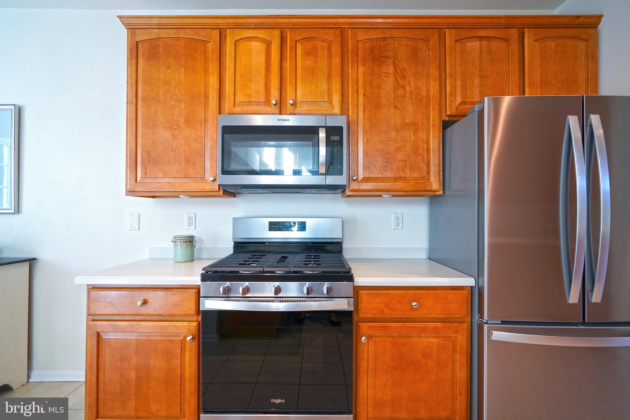 34953 Compass Cove Lewes, DE 19958 - Photo 27 of 90 a kitchen with stainless steel appliances granite countertop a refrigerator a stove a sink and dishwasher