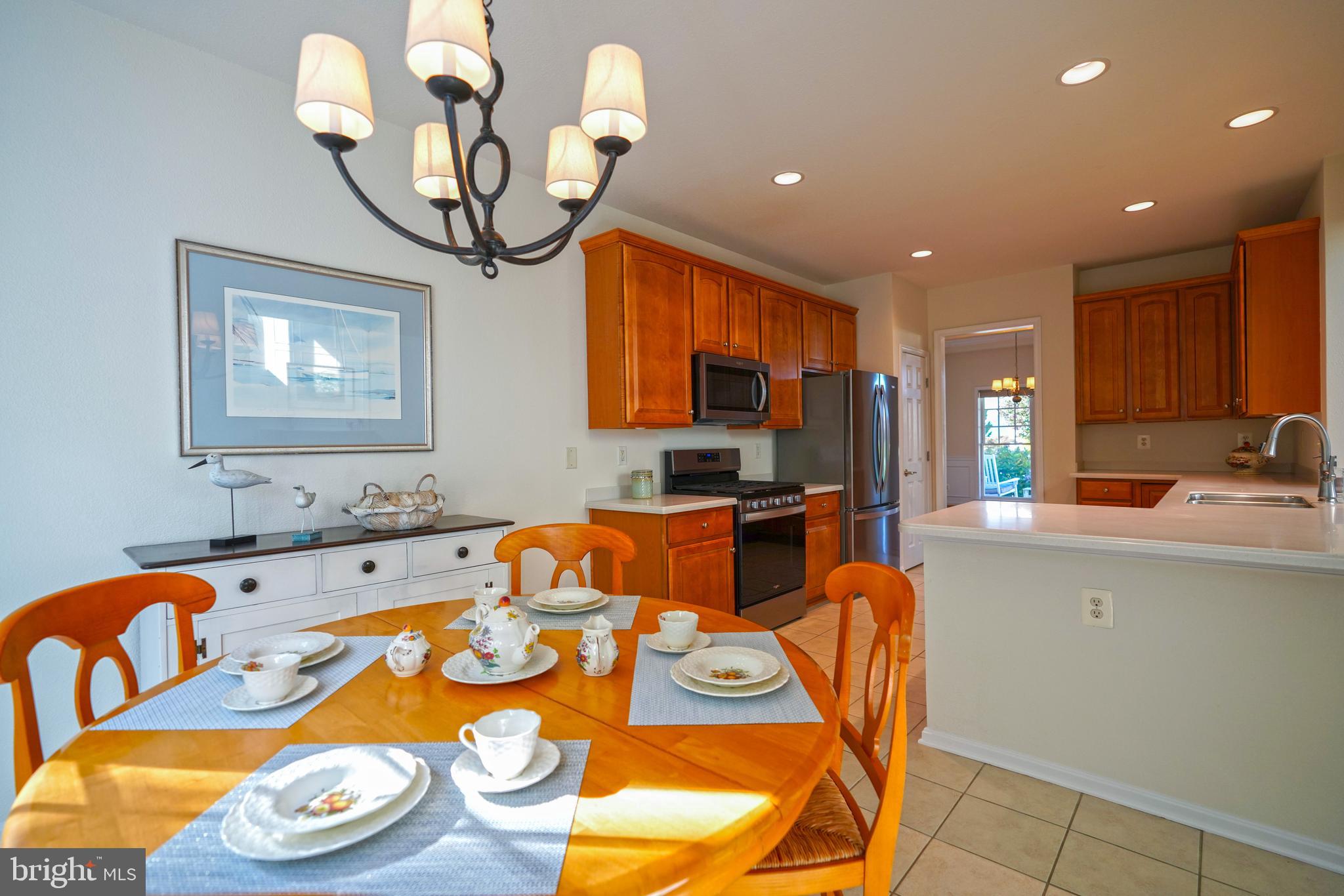 34953 Compass Cove Lewes, DE 19958 - Photo 28 of 90 a kitchen with stainless steel appliances granite countertop a sink and dishwasher a refrigerator with wooden floor