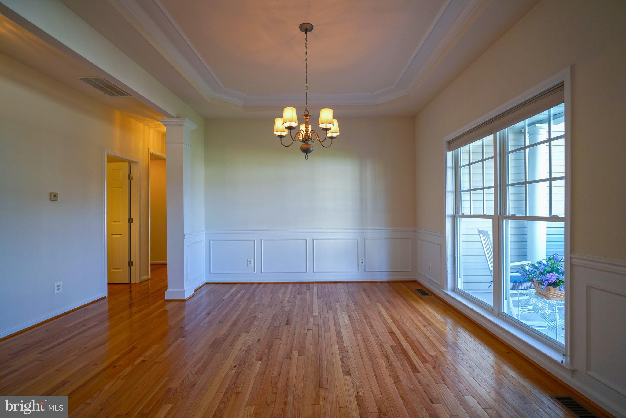 34953 Compass Cove Lewes, DE 19958 - Photo 35 of 90 a view of a room with wooden floor chandelier and windows