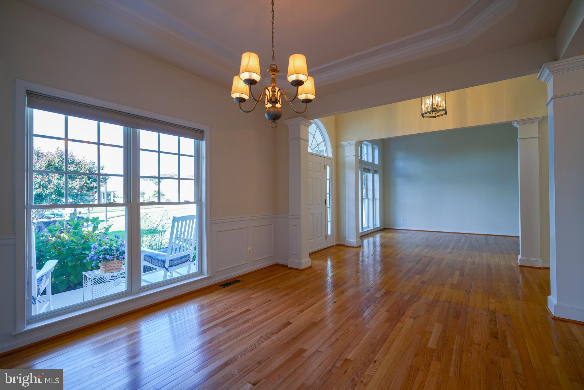 34953 Compass Cove Lewes, DE 19958 - Photo 37 of 90 a view of an empty room with wooden floor and a window