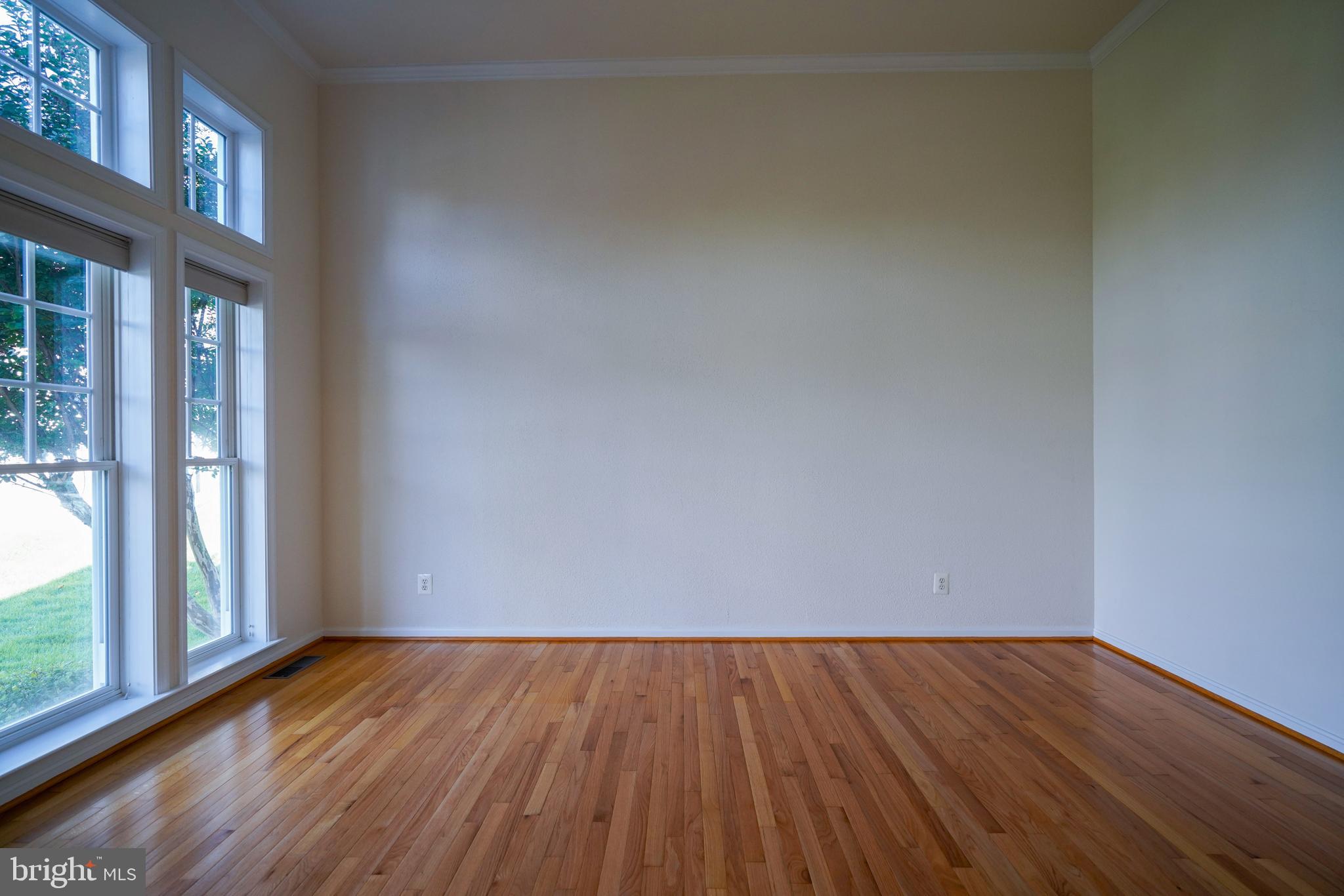 34953 Compass Cove Lewes, DE 19958 - Photo 39 of 90 a view of an empty room with wooden floor and a window