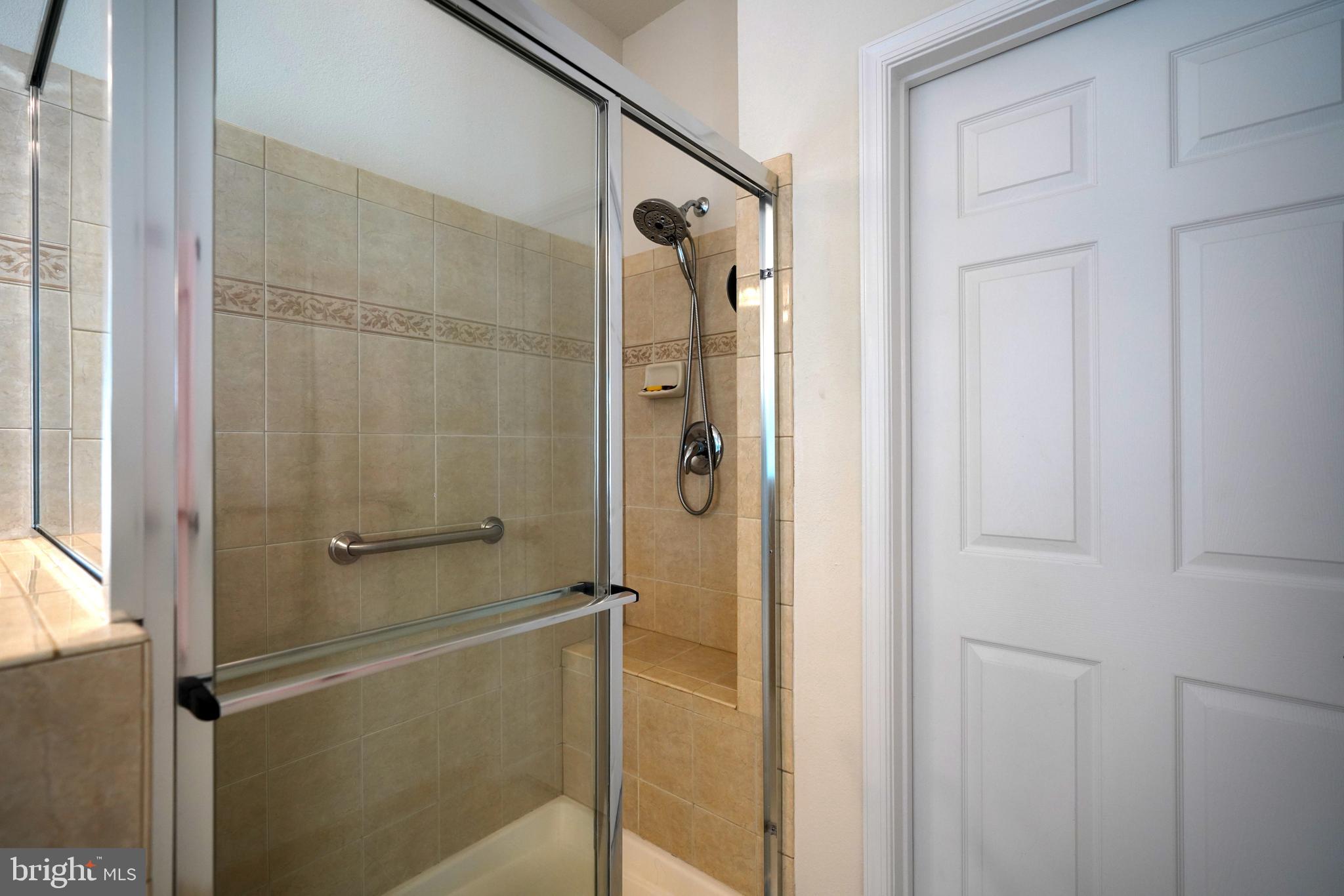 34953 Compass Cove Lewes, DE 19958 - Photo 47 of 90 a bathroom with a glass shower door