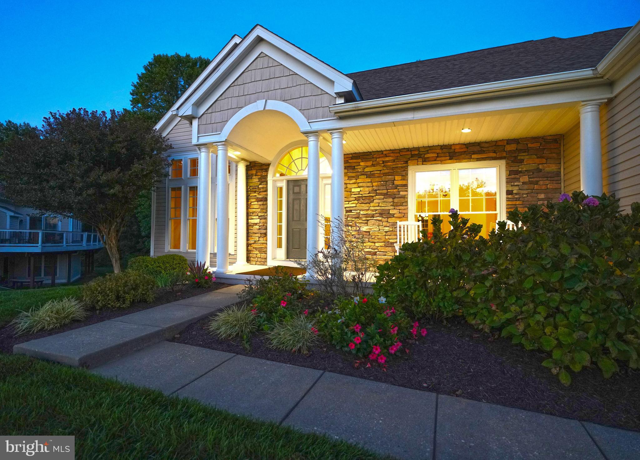 34953 Compass Cove Lewes, DE 19958 - Photo 5 of 90 a view of a house with brick walls and flower plants