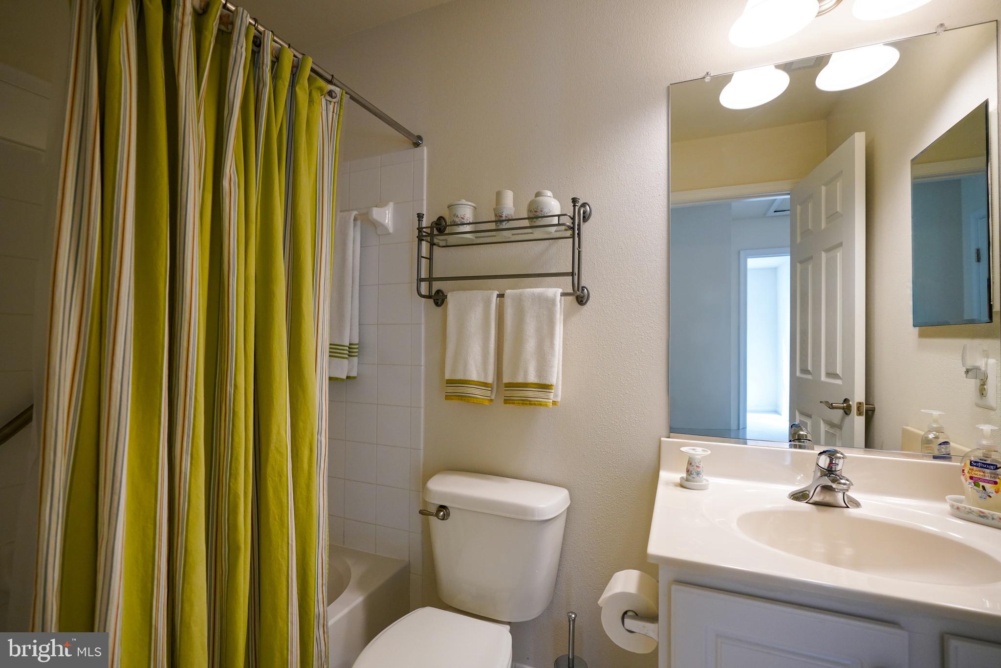 34953 Compass Cove Lewes, DE 19958 - Photo 60 of 90 a bathroom with a sink a toilet and mirror