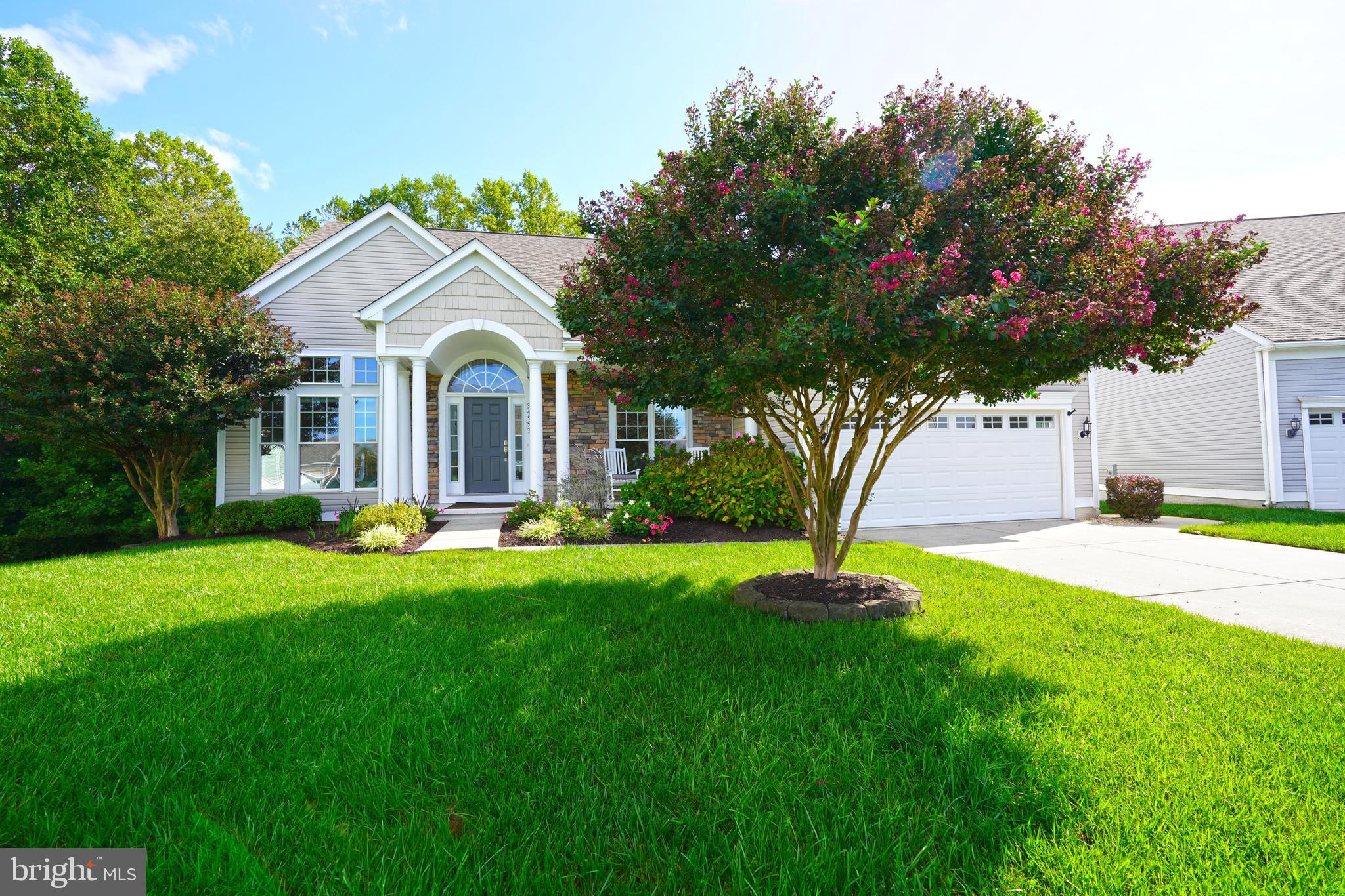 34953 Compass Cove Lewes, DE 19958 - Photo 8 of 90 a front view of a house with garden
