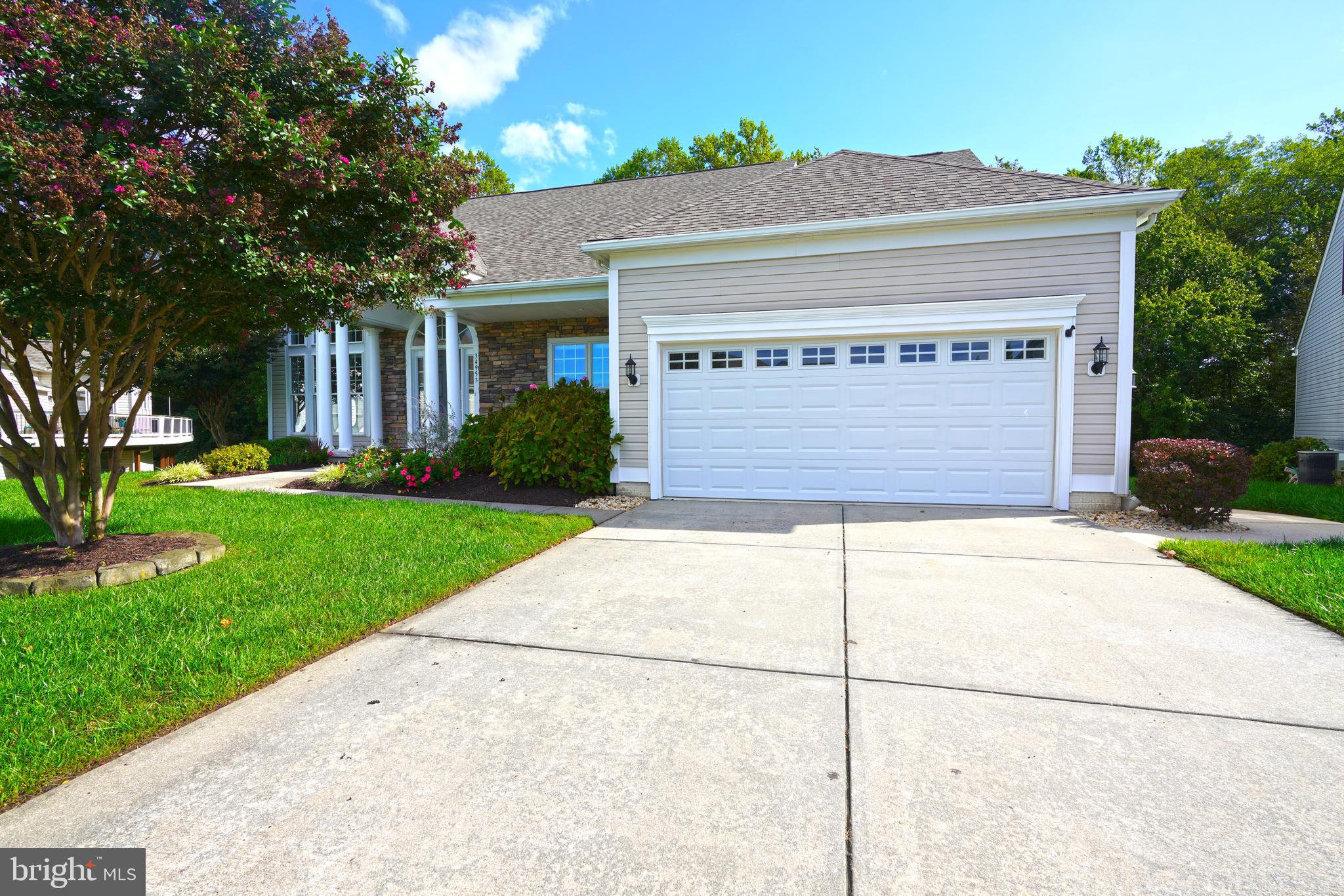 34953 Compass Cove Lewes, DE 19958 - Photo 10 of 90 a front view of a house with a yard and garage