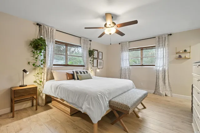 a bedroom with a bed and a chandelier