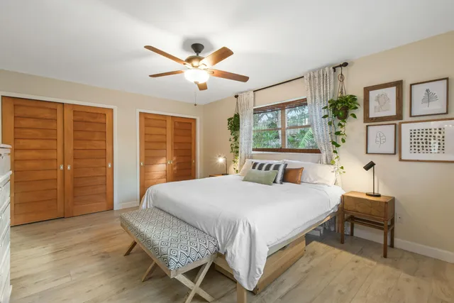 a bedroom with a balcony a bed and a chandelier