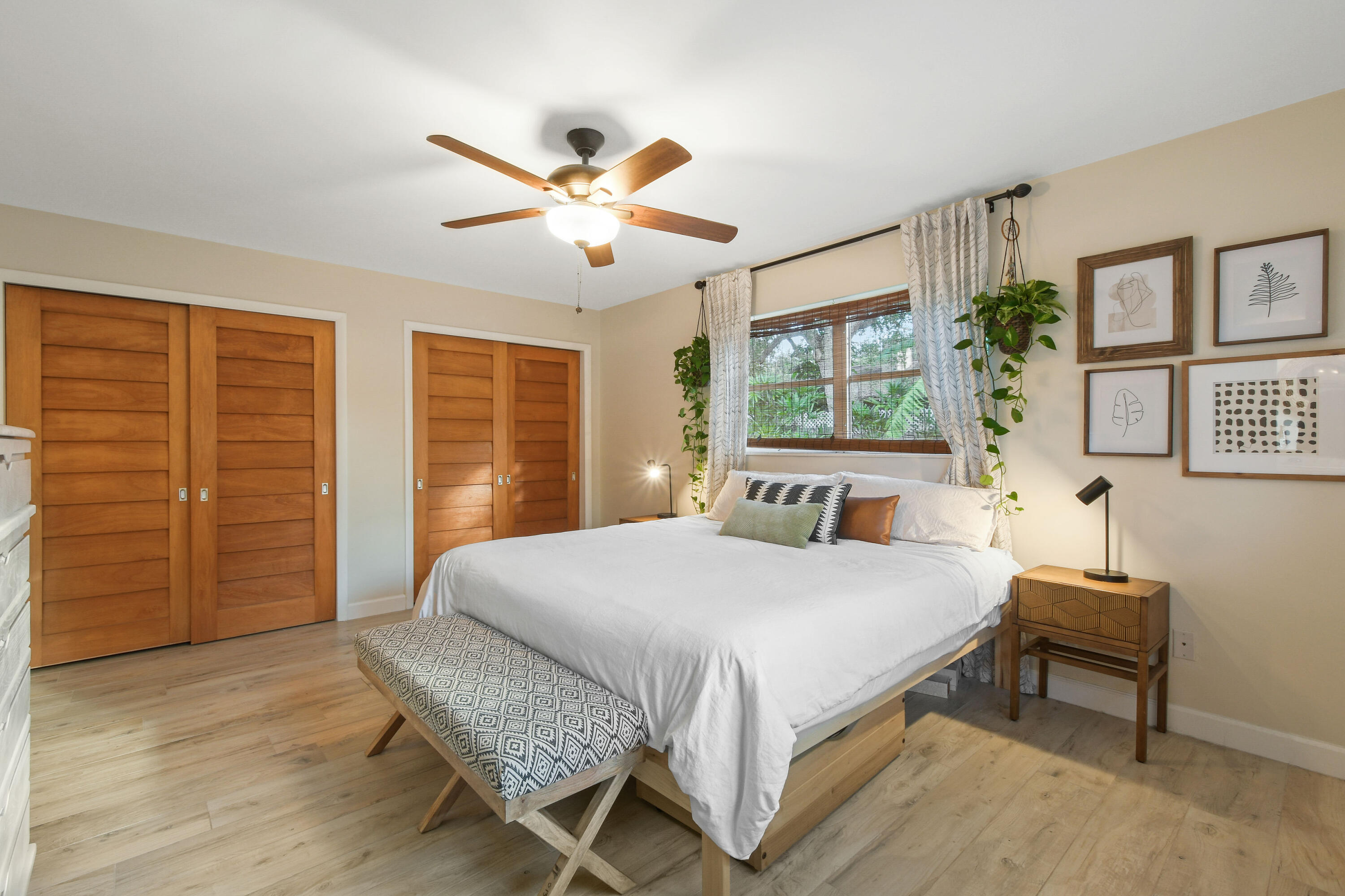 108 Norfolk Road Jupiter, FL 33469 - Photo 14 of 23 a bedroom with a balcony a bed and a chandelier