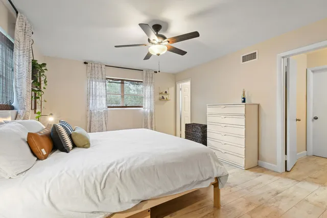 a bedroom with a bed and ceiling fan