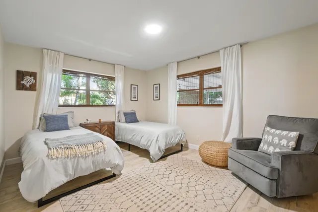 a bedroom with two beds and a couch