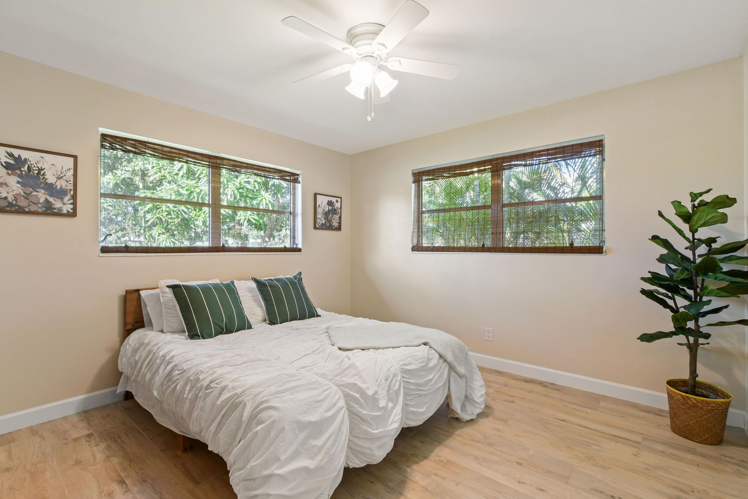 108 Norfolk Road Jupiter, FL 33469 - Photo 18 of 23 a bedroom with a bed and a potted plant