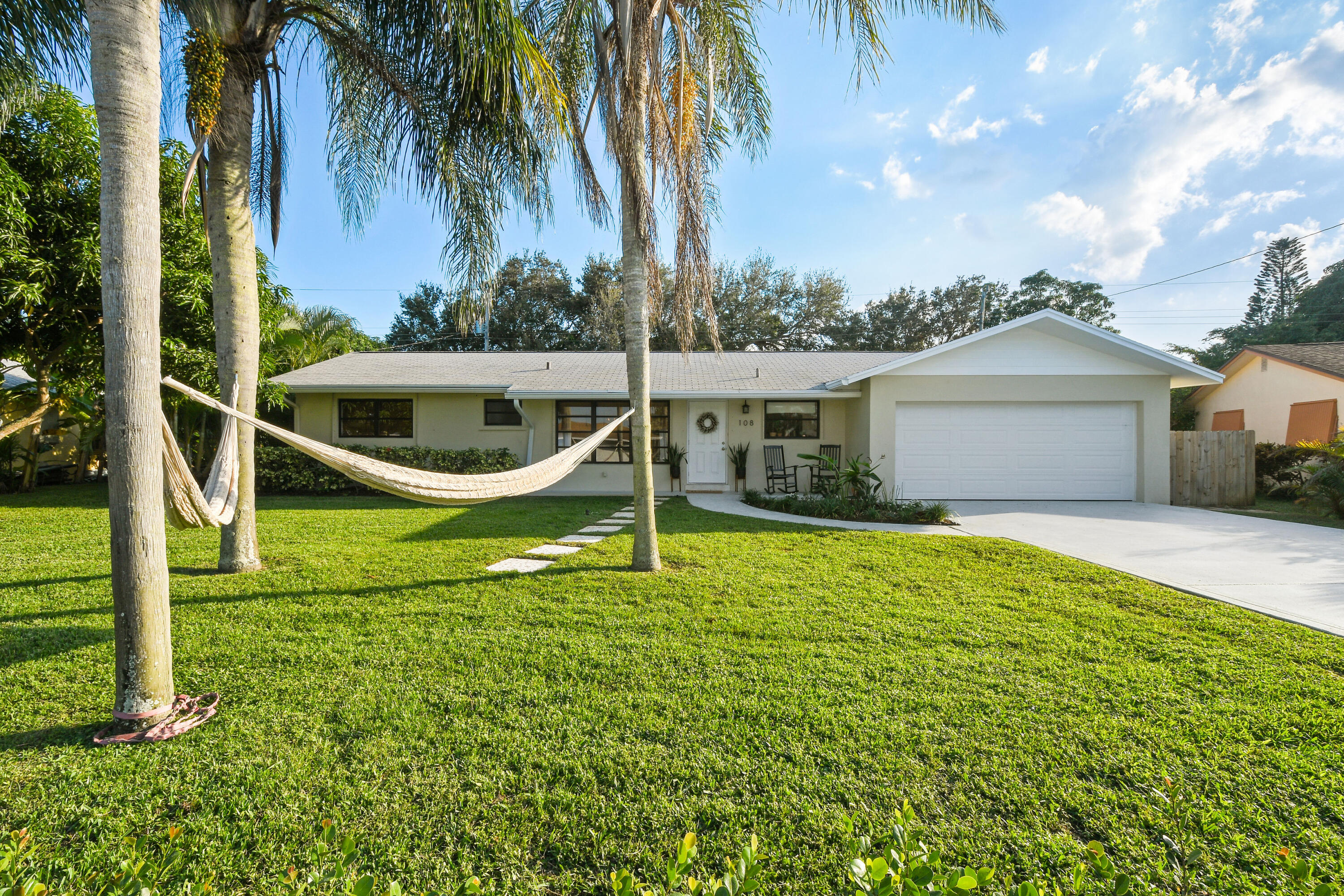 108 Norfolk Road Jupiter, FL 33469 - Photo 2 of 23 a view of a house with a backyard