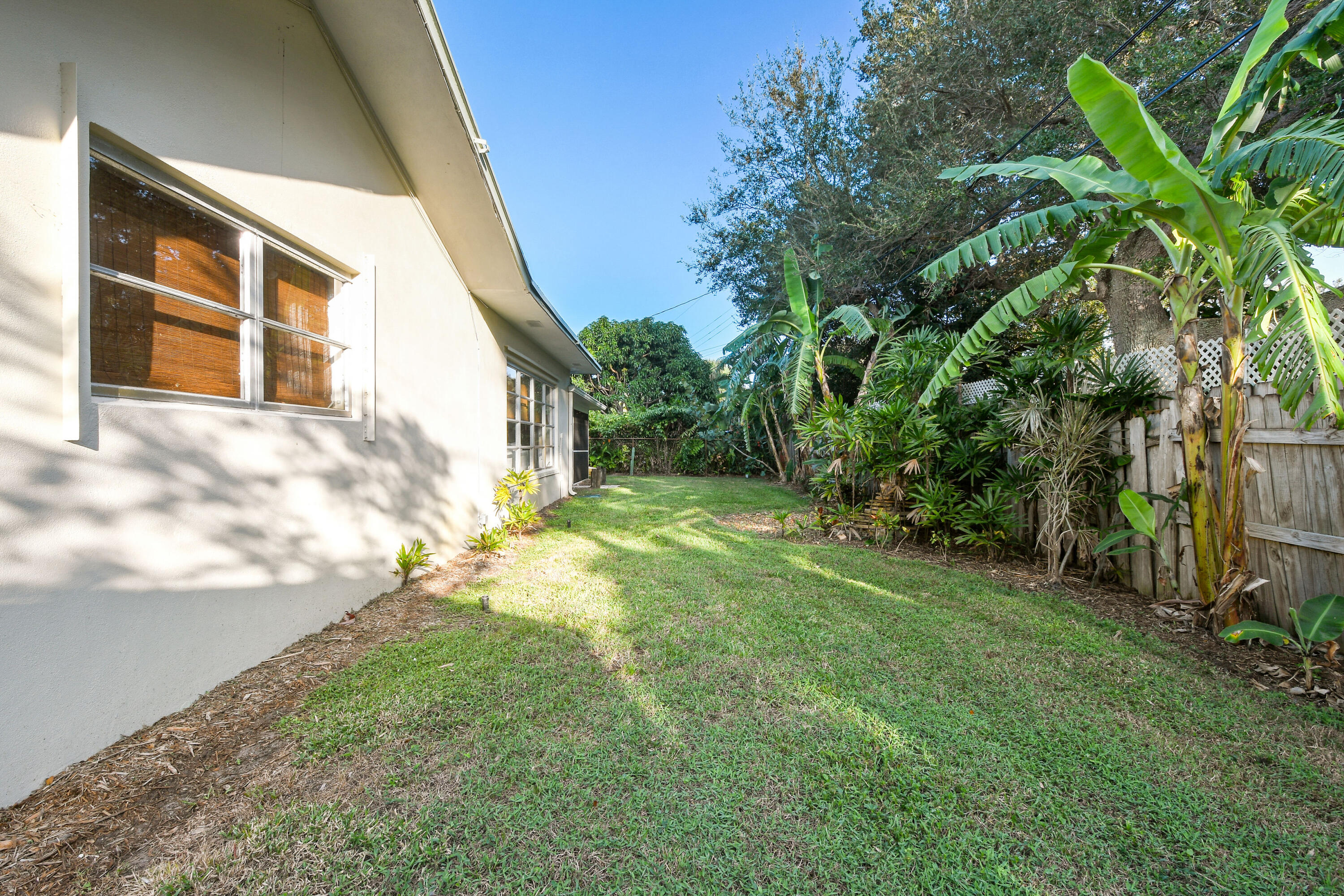 108 Norfolk Road Jupiter, FL 33469 - Photo 23 of 23 a view of a yard in front of a house with a large tree