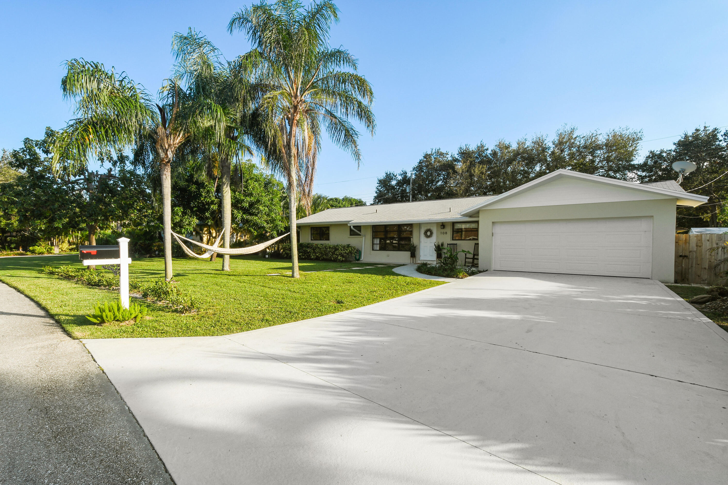 108 Norfolk Road Jupiter, FL 33469 - Photo 3 of 23 a front view of a house with garden