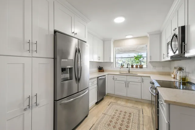 a kitchen with a refrigerator sink and microwave