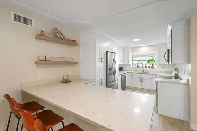 a kitchen with refrigerator and cabinets