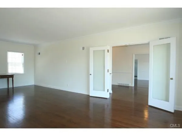 a view of an empty room and wooden floor