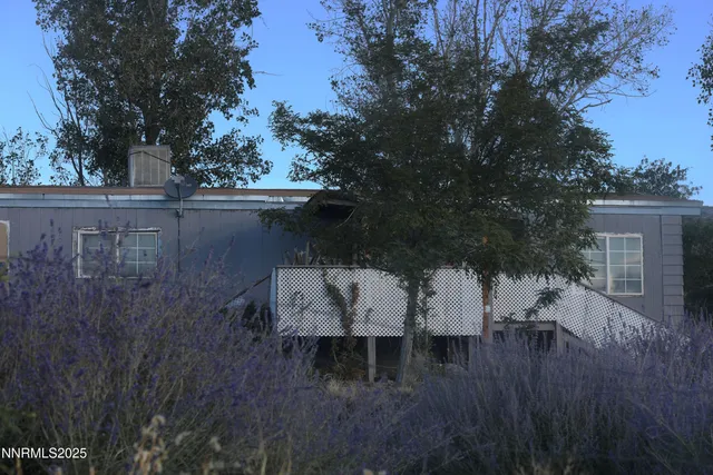 a view of house with patio and wooden floor
