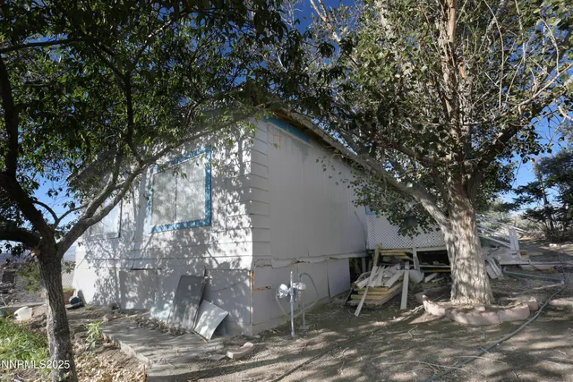 a backyard of a house with table and chairs