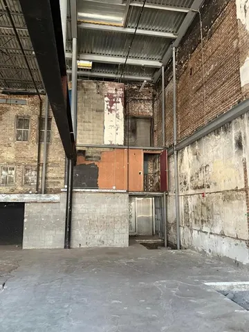 a view of empty room with wooden floor and windows