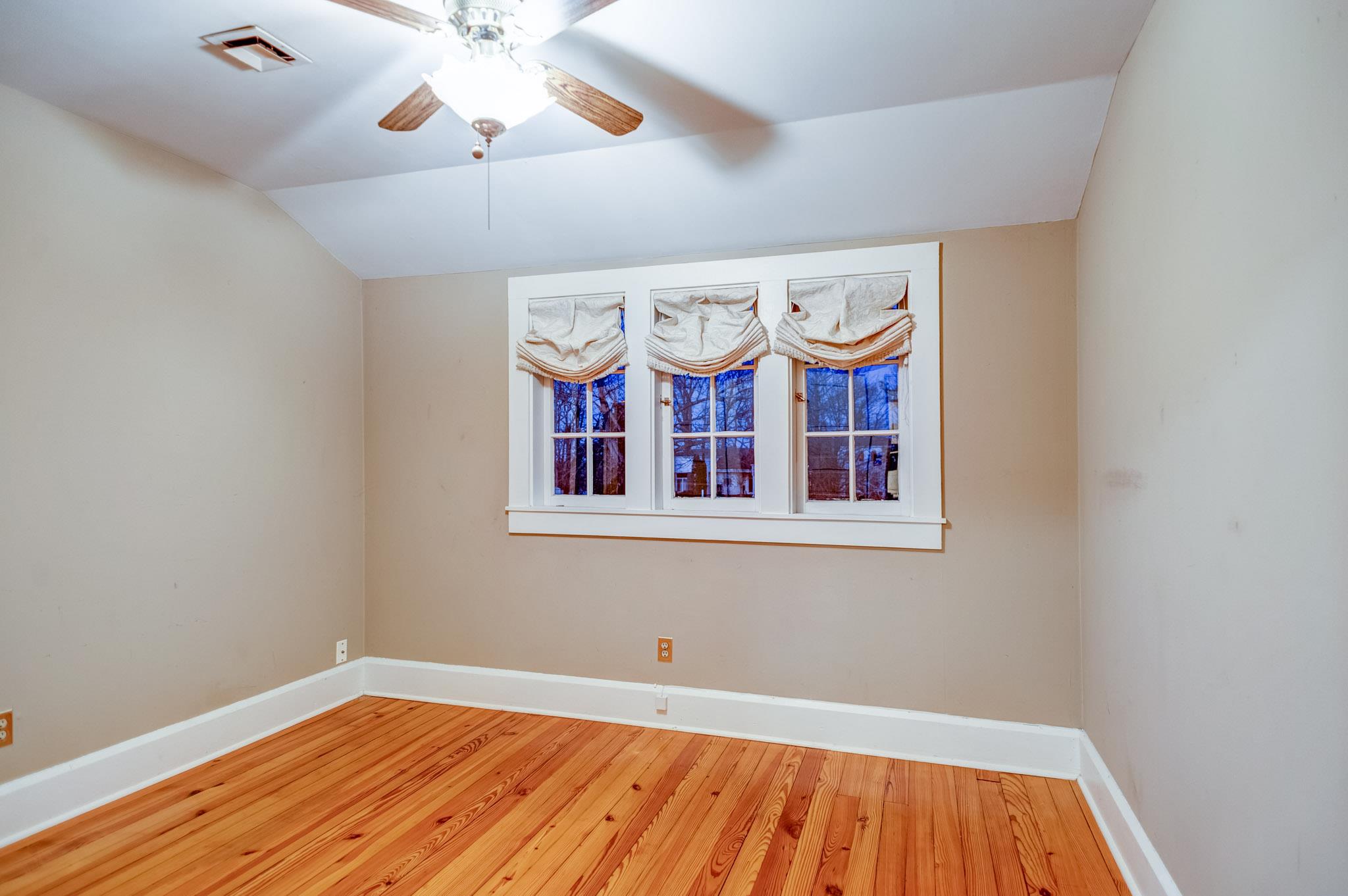 1300 Riverside Drive Old Hickory, TN 37138 - Photo 13 of 24 an empty room with wooden floor fan and windows