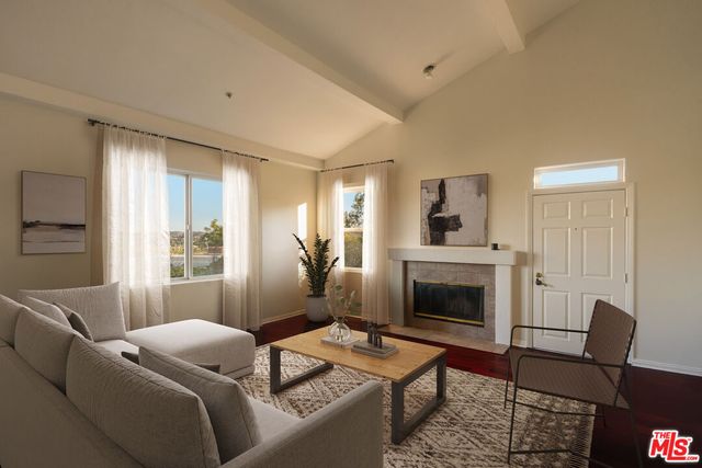 a living room with furniture fireplace and a flat screen tv