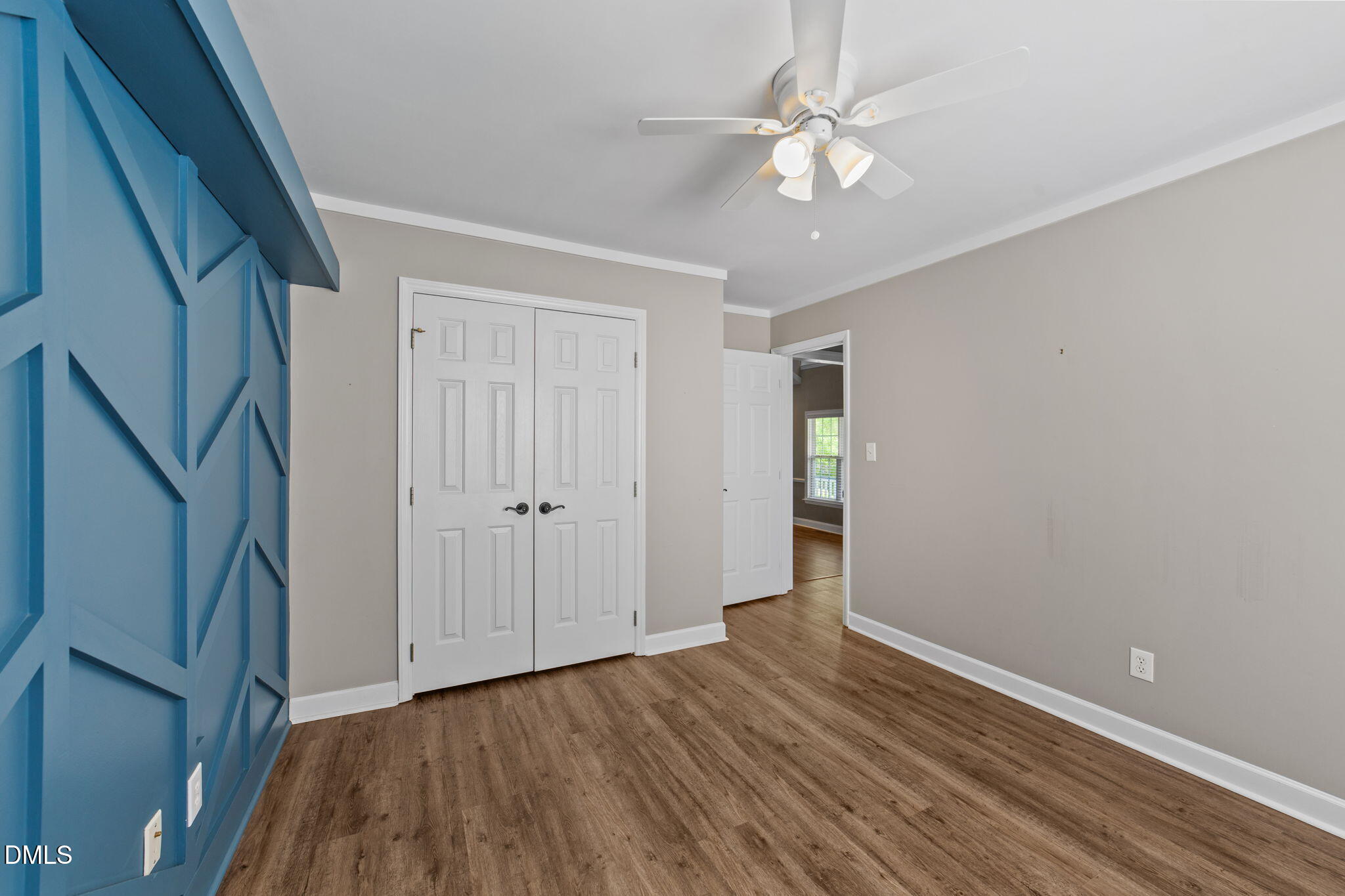 6820 Oviedo Drive Raleigh, NC 27603 - Photo 28 of 50 a view of an empty room with wooden floor and a ceiling fan