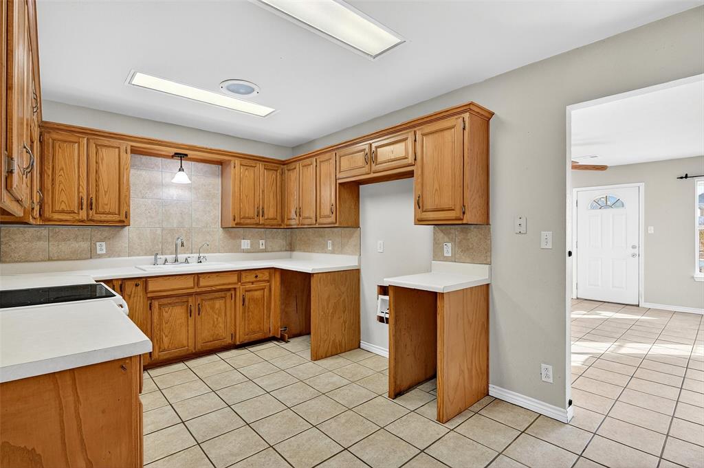 538 Lakewood Road Denison, TX 75020 - Photo 11 of 35 a kitchen with stainless steel appliances granite countertop a sink and dishwasher a refrigerator with wooden cabinets