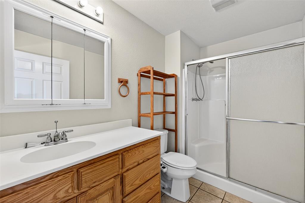 538 Lakewood Road Denison, TX 75020 - Photo 17 of 35 a bathroom with a sink toilet and shower
