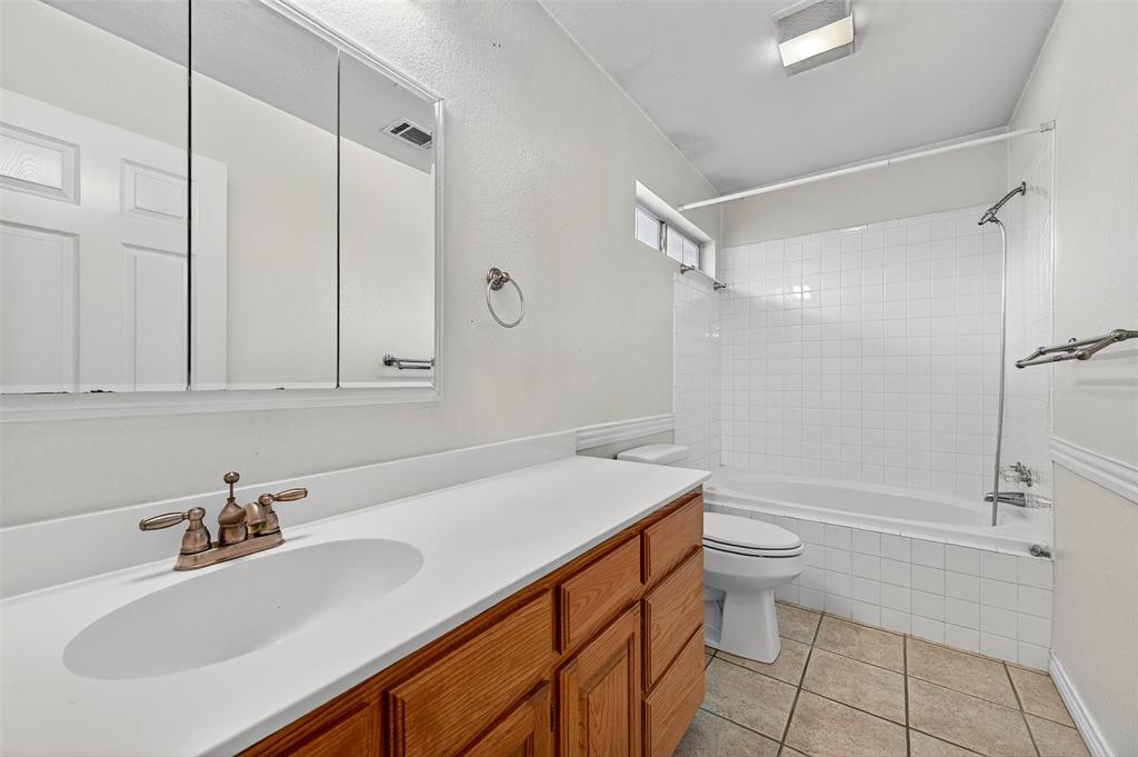 538 Lakewood Road Denison, TX 75020 - Photo 25 of 35 a bathroom with a sink toilet and shower