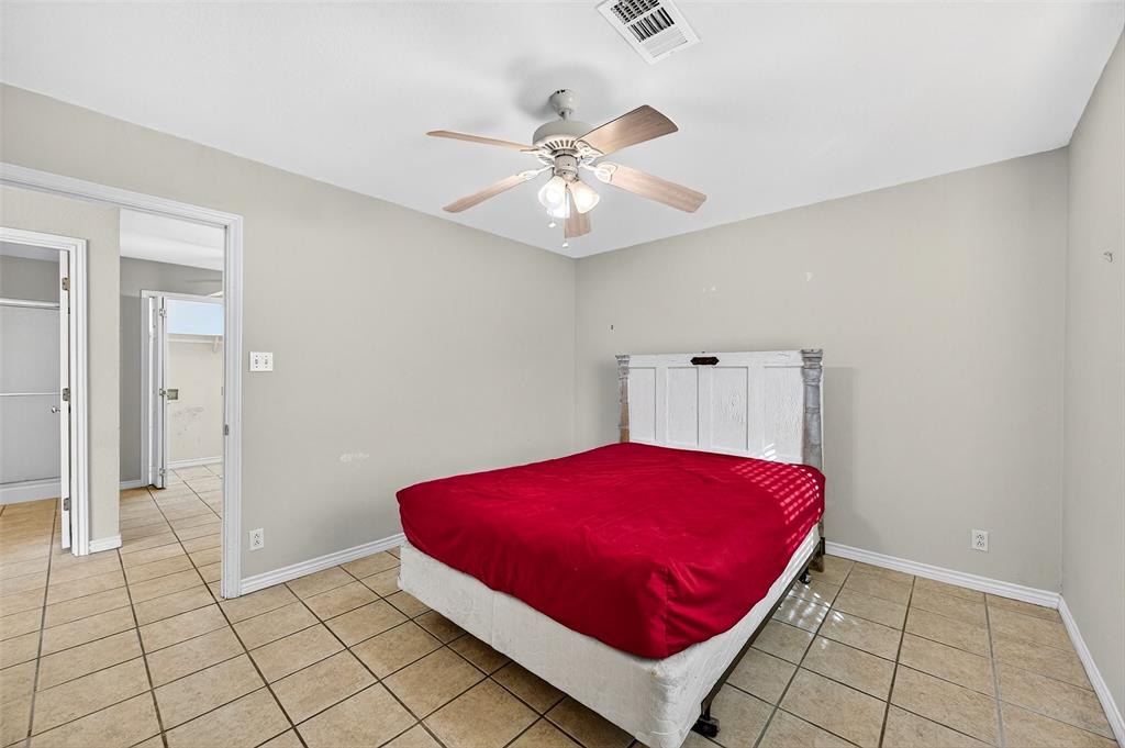 538 Lakewood Road Denison, TX 75020 - Photo 26 of 35 a bedroom with a bed and a chandelier fan