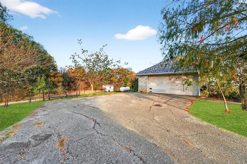 538 Lakewood Road Denison, TX 75020 - Photo 27 of 35 a front view of a house with a yard and garage